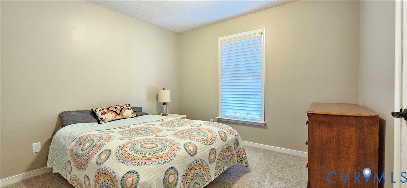 2239 Mantapike Landing Road Stevensville, VA 23161 - Photo 10 of 22 a bedroom with a bed and a window