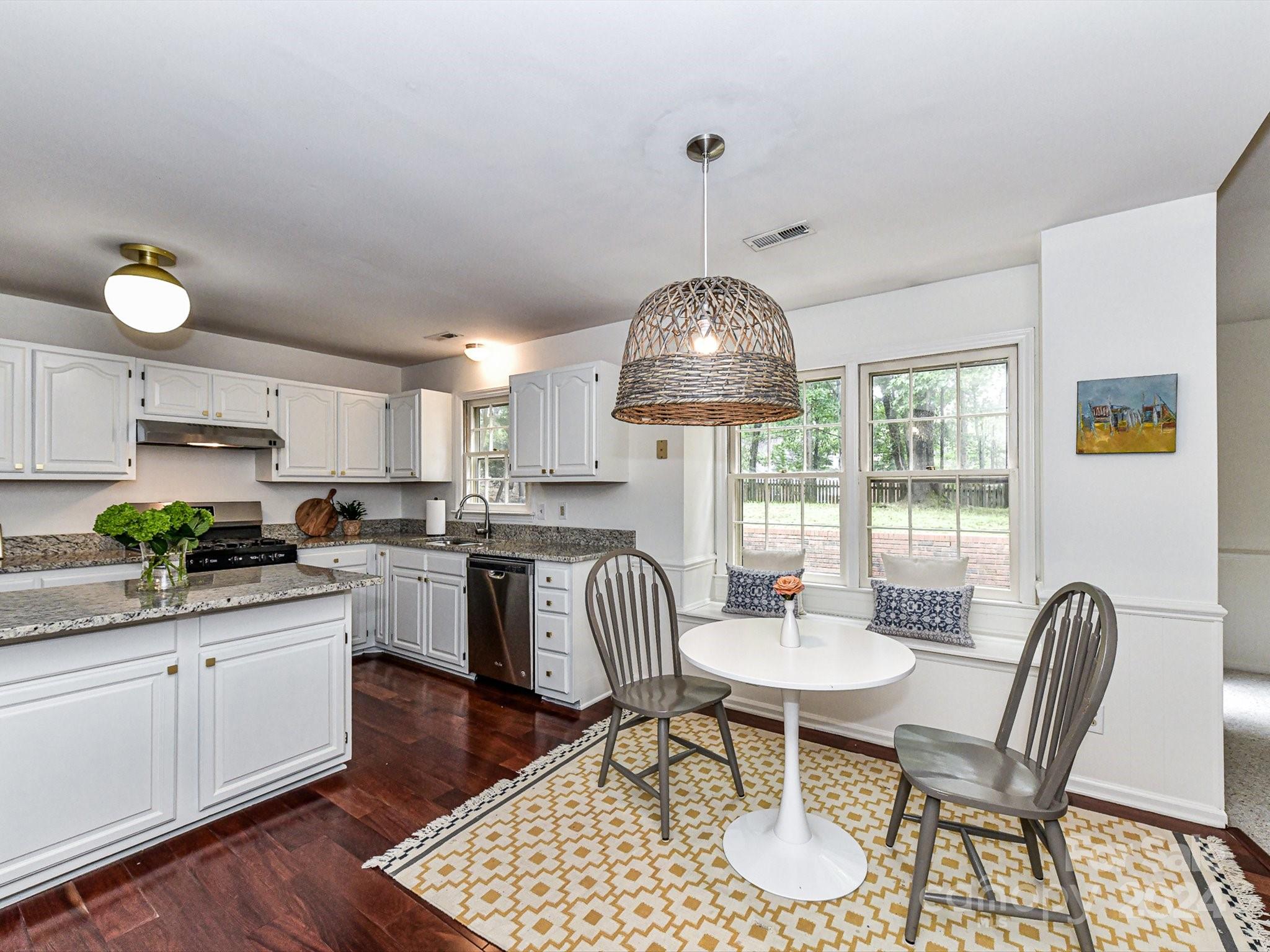 717 Fredricksburg Road Matthews, NC 28105 - Photo 12 of 34 a kitchen with a dining table and chairs