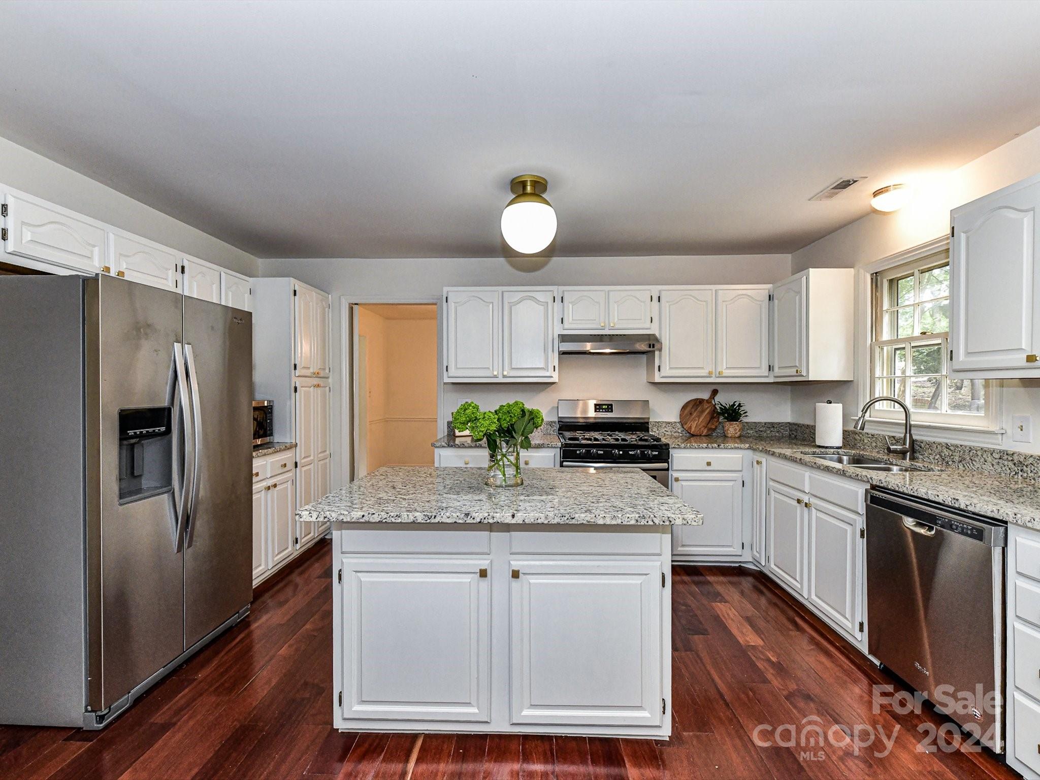 717 Fredricksburg Road Matthews, NC 28105 - Photo 15 of 34 a kitchen with white cabinets and stainless steel appliances