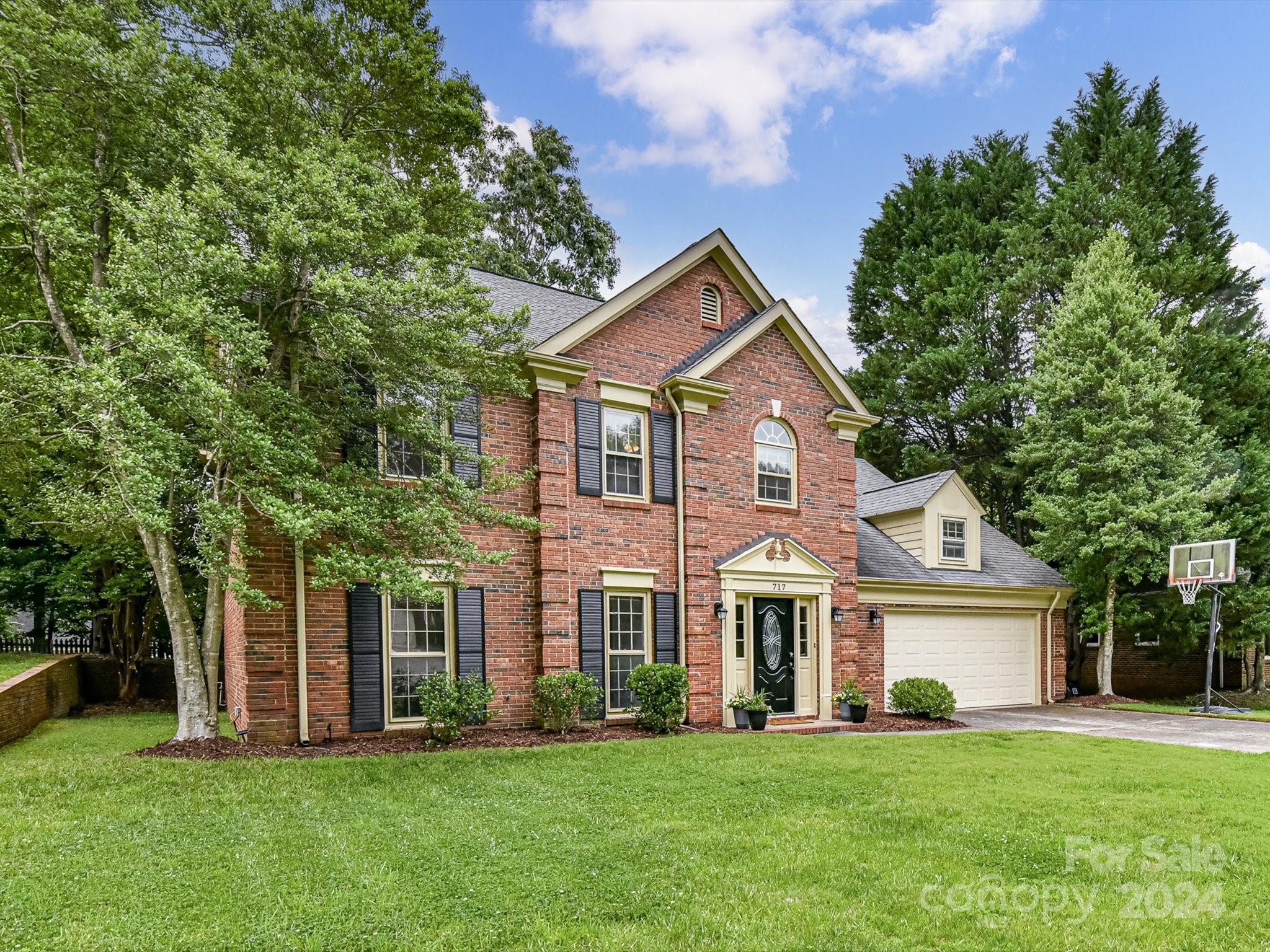 717 Fredricksburg Road Matthews, NC 28105 - Photo 2 of 34 a front view of a house with a garden and trees