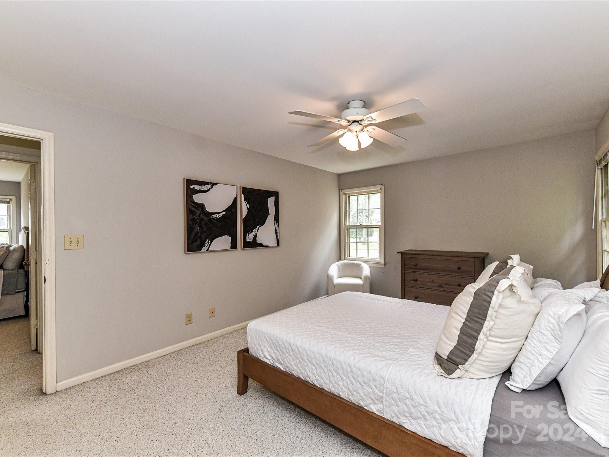 717 Fredricksburg Road Matthews, NC 28105 - Photo 23 of 34 a bedroom with a bed and a chandelier