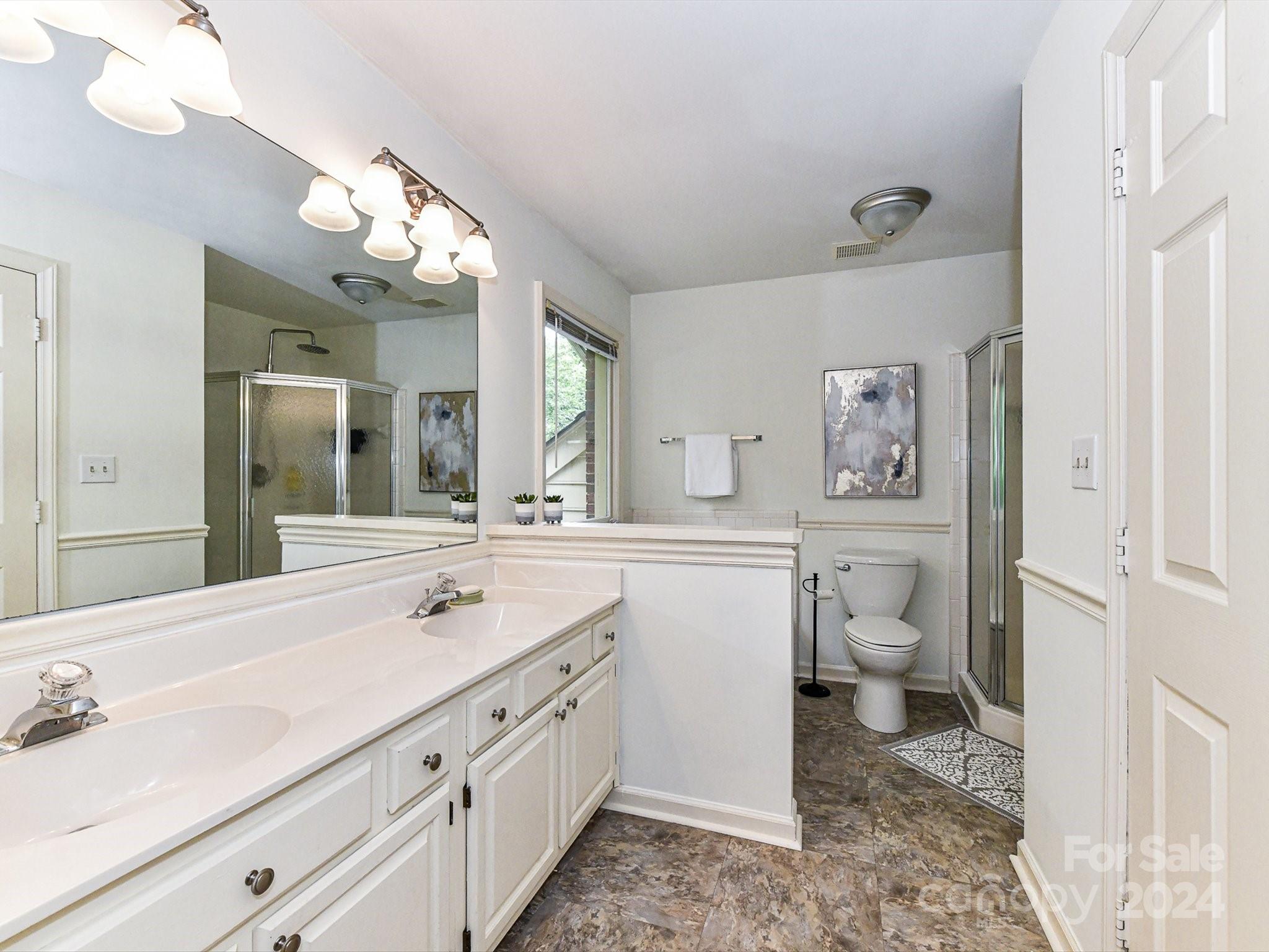 717 Fredricksburg Road Matthews, NC 28105 - Photo 24 of 34 a spacious bathroom with a toilet sink and mirror