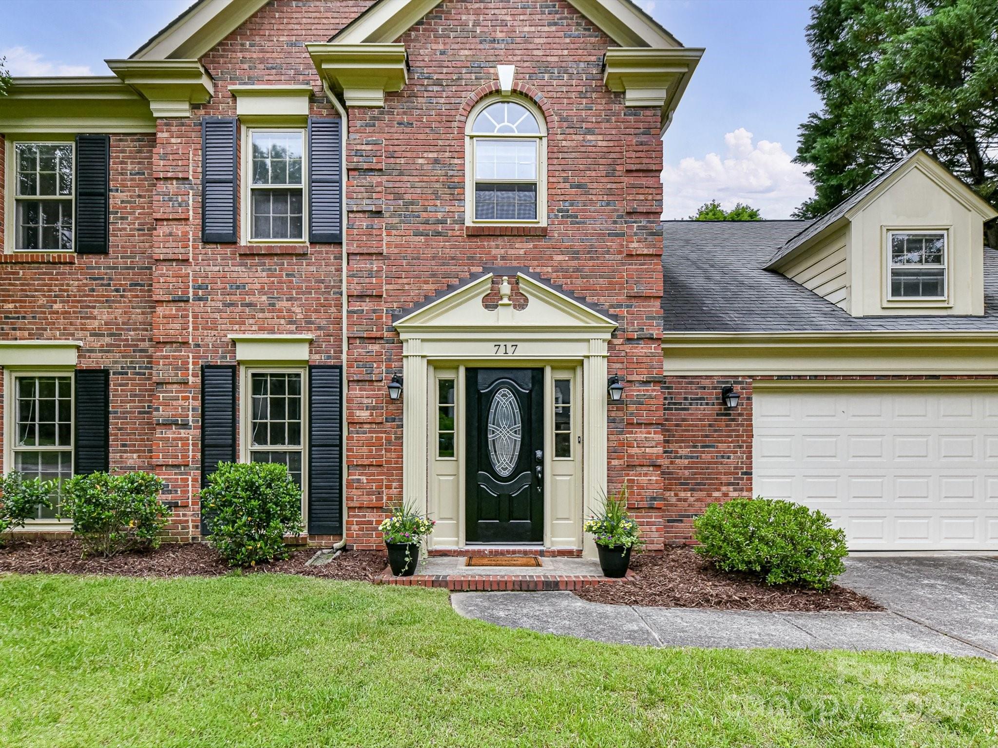 717 Fredricksburg Road Matthews, NC 28105 - Photo 3 of 34 a front view of a house with garden