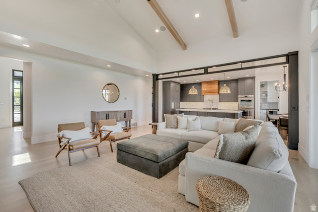 1720 Hillcrest Circle Mapleton, UT 84664 - Photo 41 of 116 Living room with a chandelier, light wood-style flooring, and vaulted ceiling