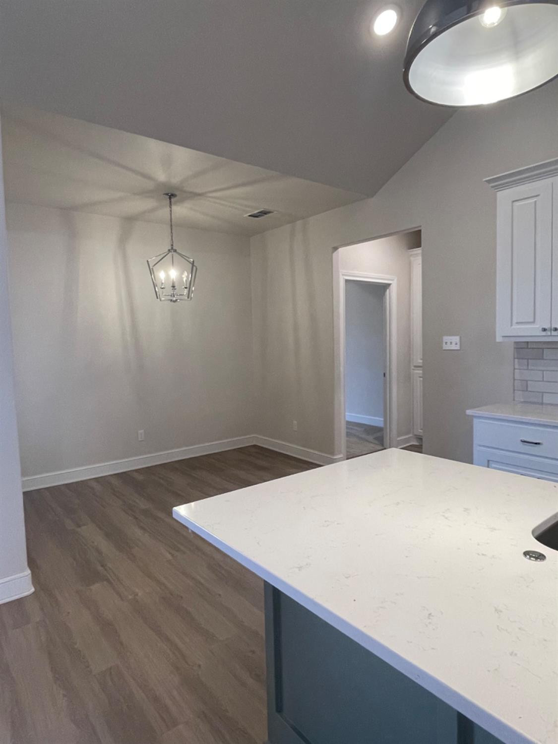 5718 119th Lubbock, TX 79424 - Photo 3 of 17 a room with a bed and a chandelier