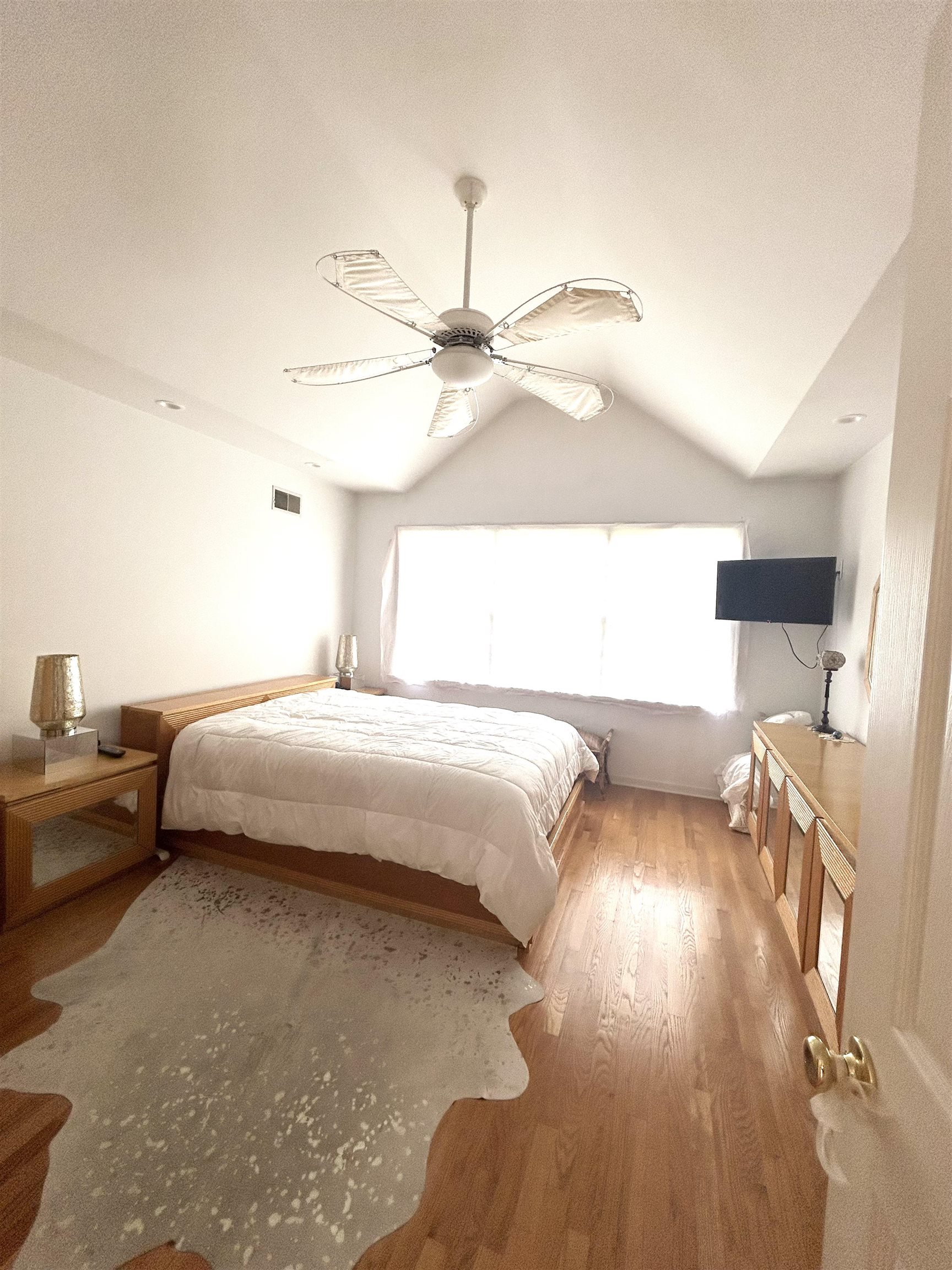 302 Grand Ridge Drive, Unit 302 Ridgefield, NJ 07657 - Photo 11 of 47 a bedroom with a bed and a chandelier