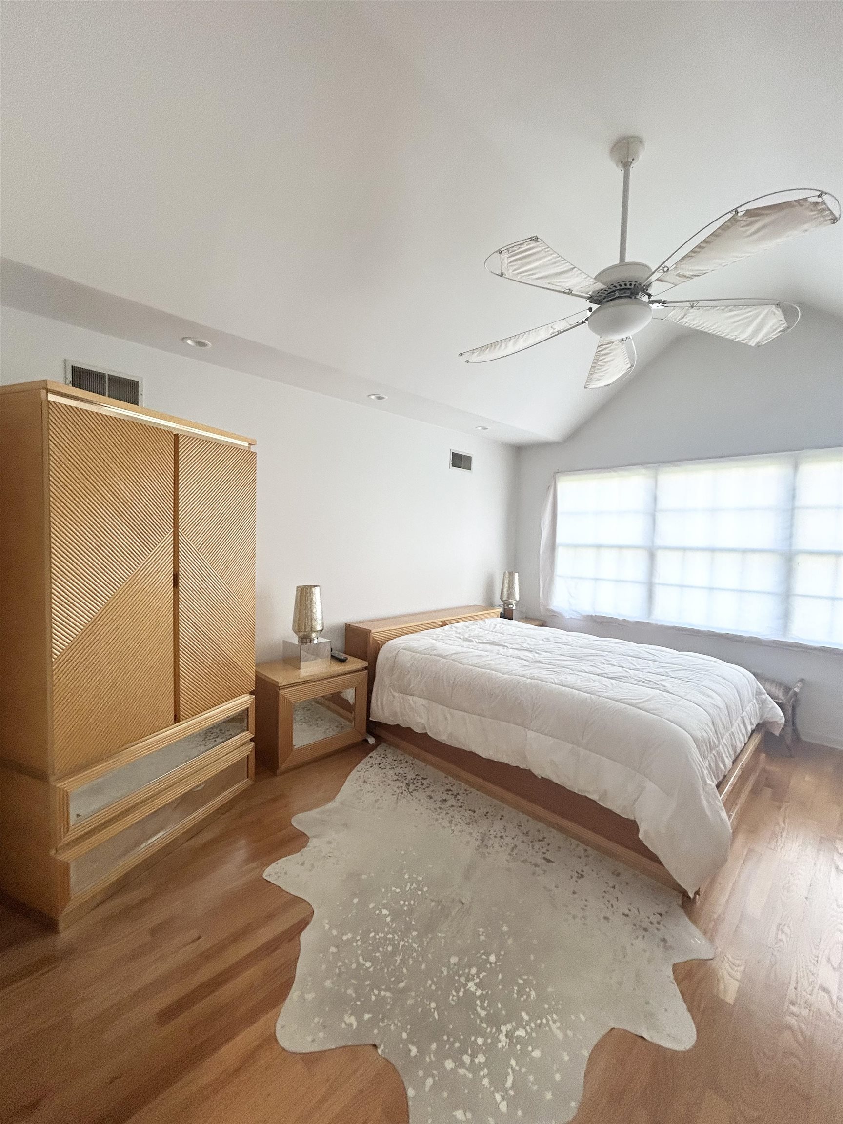 302 Grand Ridge Drive, Unit 302 Ridgefield, NJ 07657 - Photo 12 of 47 a bedroom with a bed and a chandelier