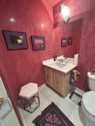 a bathroom with a toilet a sink and mirror