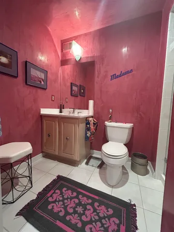 a bathroom with a toilet a sink and mirror