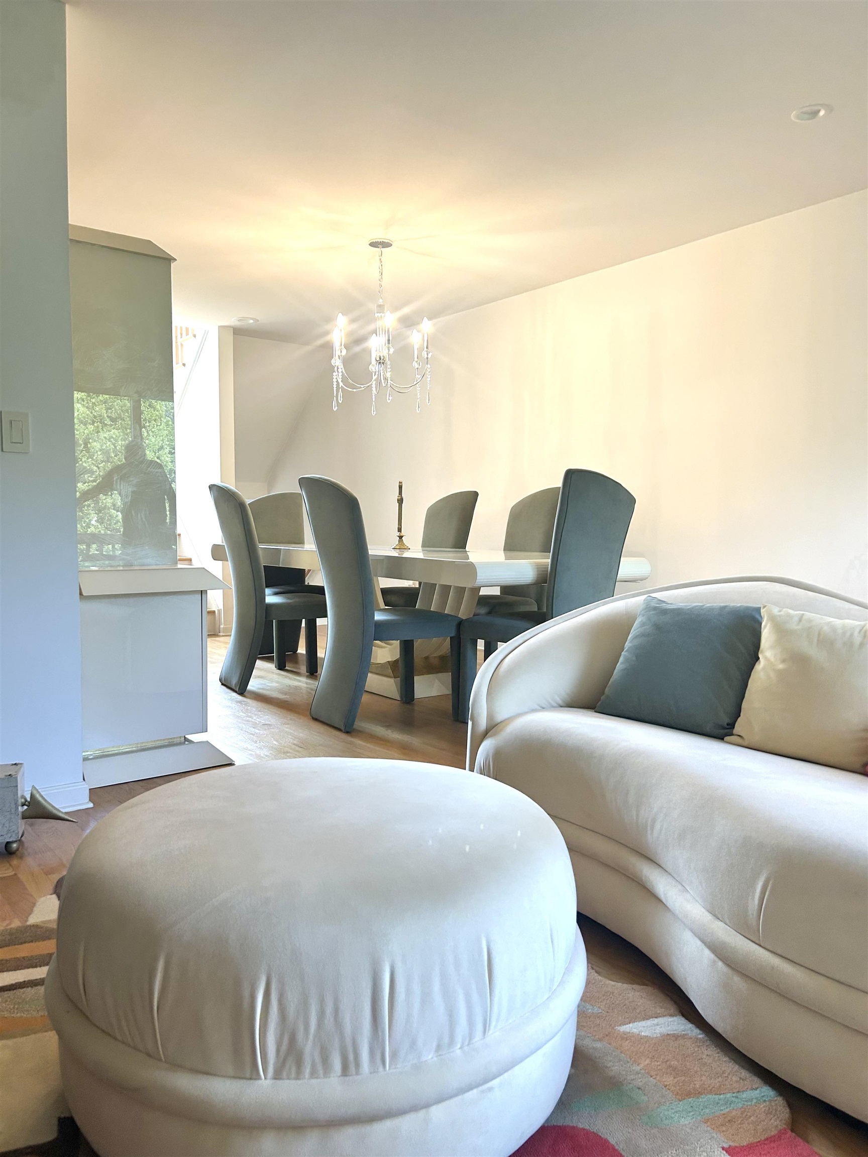 302 Grand Ridge Drive, Unit 302 Ridgefield, NJ 07657 - Photo 2 of 47 a living room with couches chairs and chandelier