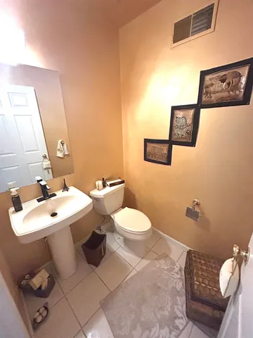 a bathroom with a sink mirror and toilet