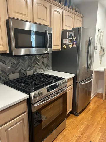 a kitchen with granite countertop a stove and a microwave