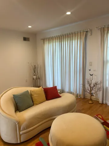 a blue couch sitting in a room next to a window