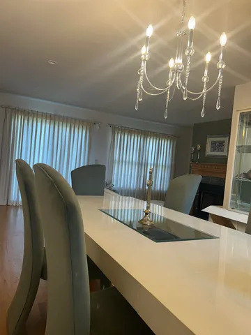 a view of a dining room with furniture and a chandelier