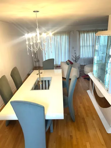 a kitchen with a table chairs and a wooden floor