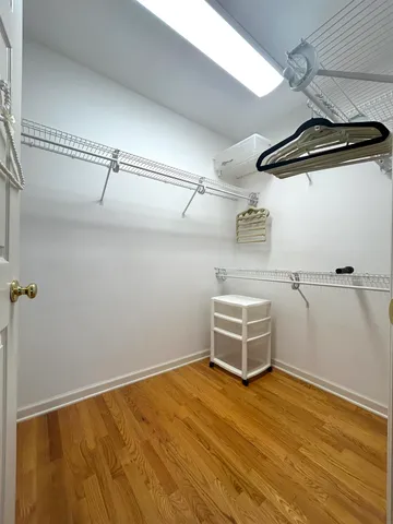 a room with a wooden floor and white walls