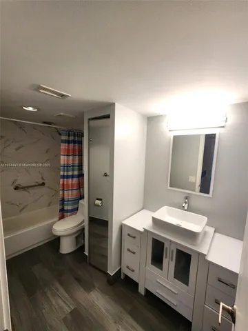 a view of a hallway to a livingroom with furniture