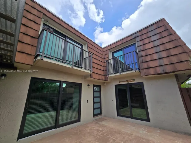 a view of a house with a door and wooden floor