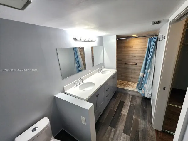 a bathroom with a sink vanity and a mirror