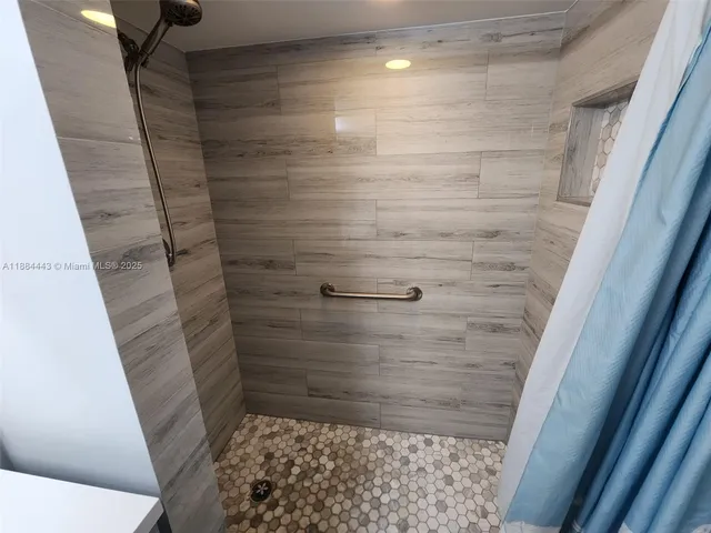 a view of an empty room with wooden walls