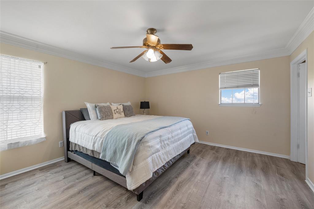 3433 West Tours Road West, TX 76691 - Photo 23 of 40 Bedroom featuring crown molding, light wood-type flooring, and a ceiling fan