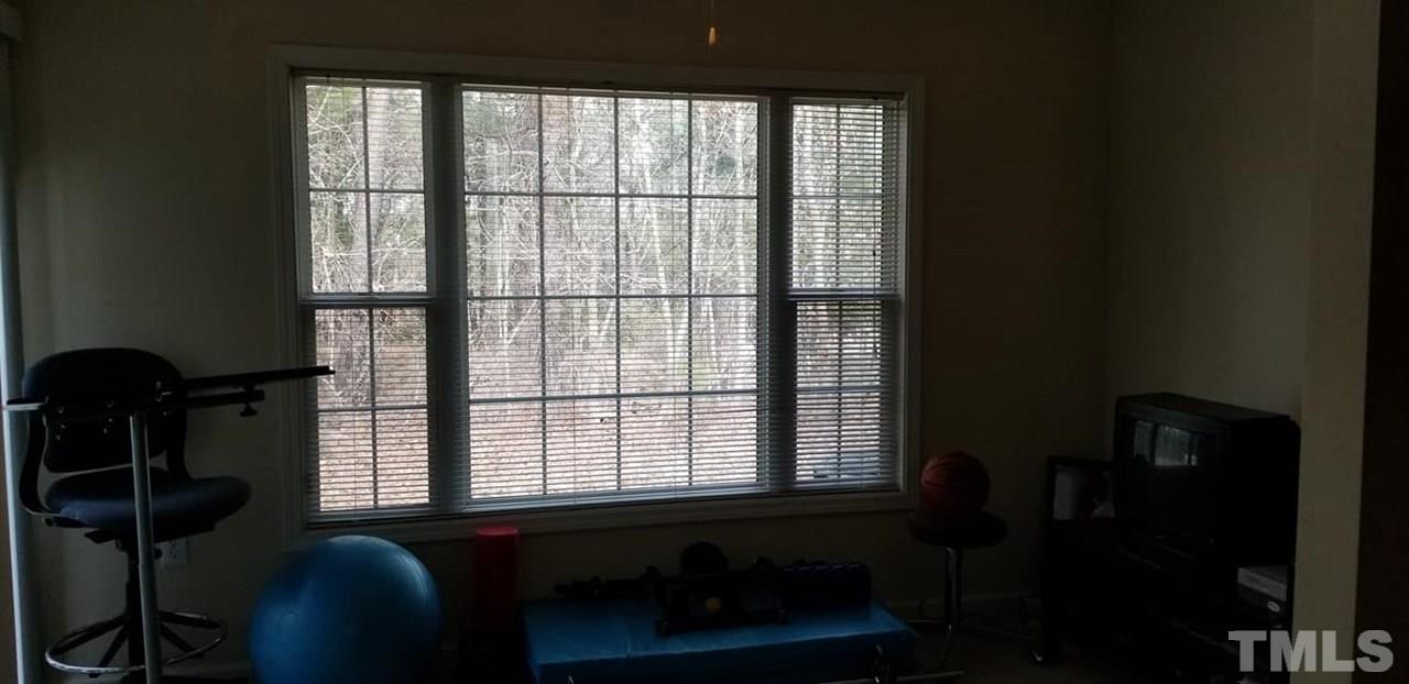 11341 Involute Place, Unit 101 Raleigh, NC 27617 - Photo 10 of 20 Versatile sun room with sliding glass door that leads to the back patio.