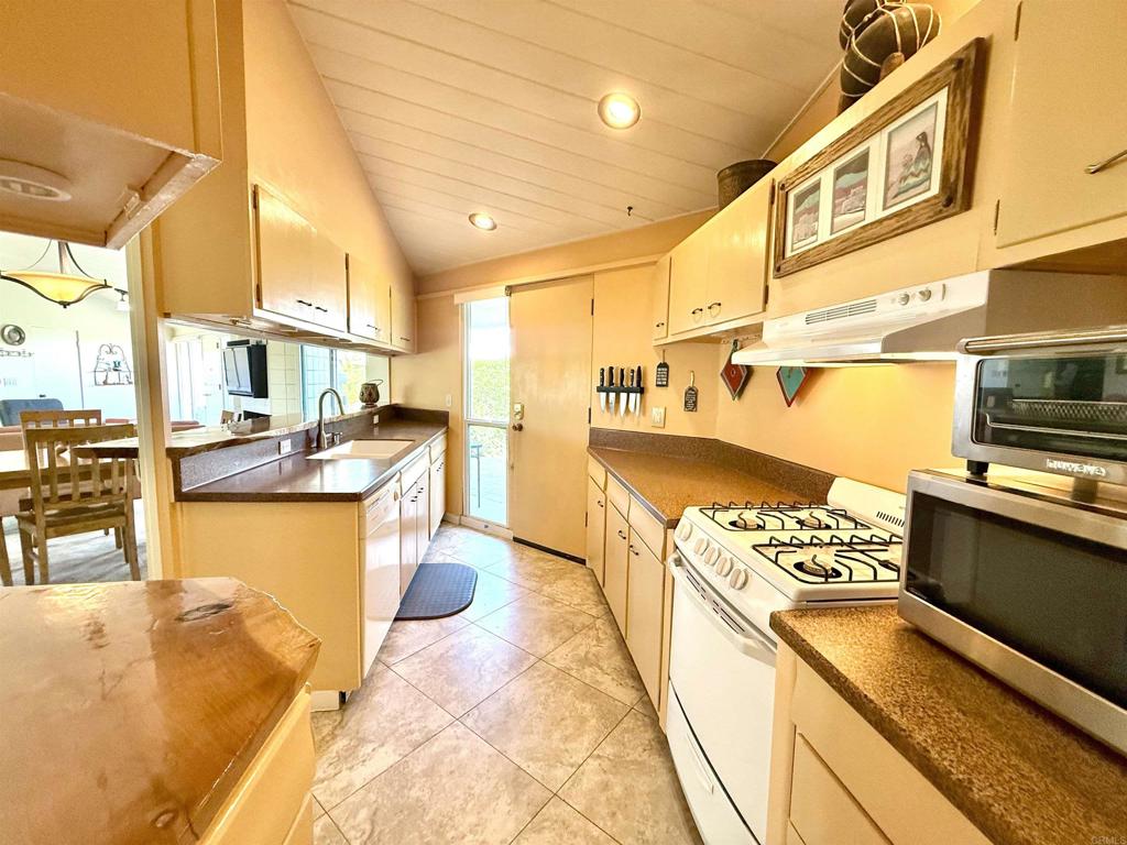 37800 Da Vall Drive, Unit 10 Rancho Mirage, CA 92270 - Photo 16 of 31 a kitchen with stainless steel appliances kitchen island granite countertop a sink and cabinets