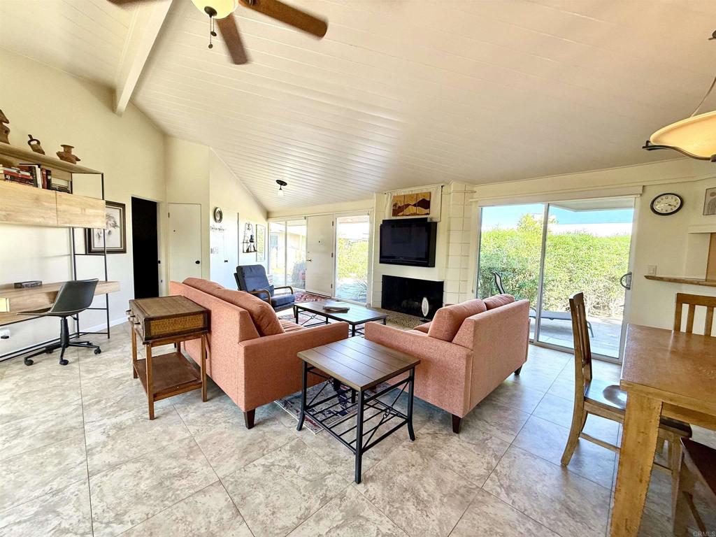 37800 Da Vall Drive, Unit 10 Rancho Mirage, CA 92270 - Photo 3 of 31 a living room with furniture and a flat screen tv
