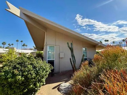 a view of a house with a flower garden