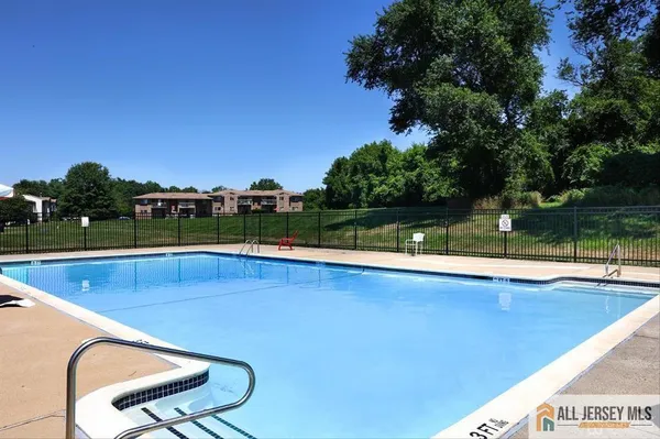a view of a swimming pool with a yard