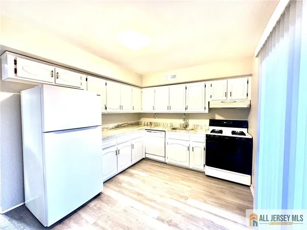 a kitchen with stainless steel appliances a refrigerator sink and cabinets