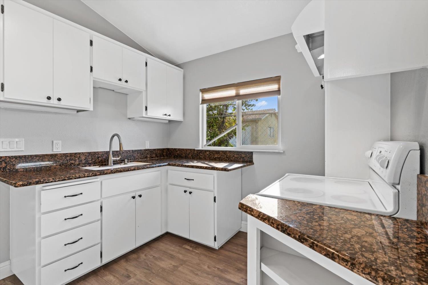 8335 Bailey Road Yuba City, CA 95993 - Photo 11 of 56 a kitchen with granite countertop a sink a stove and cabinets