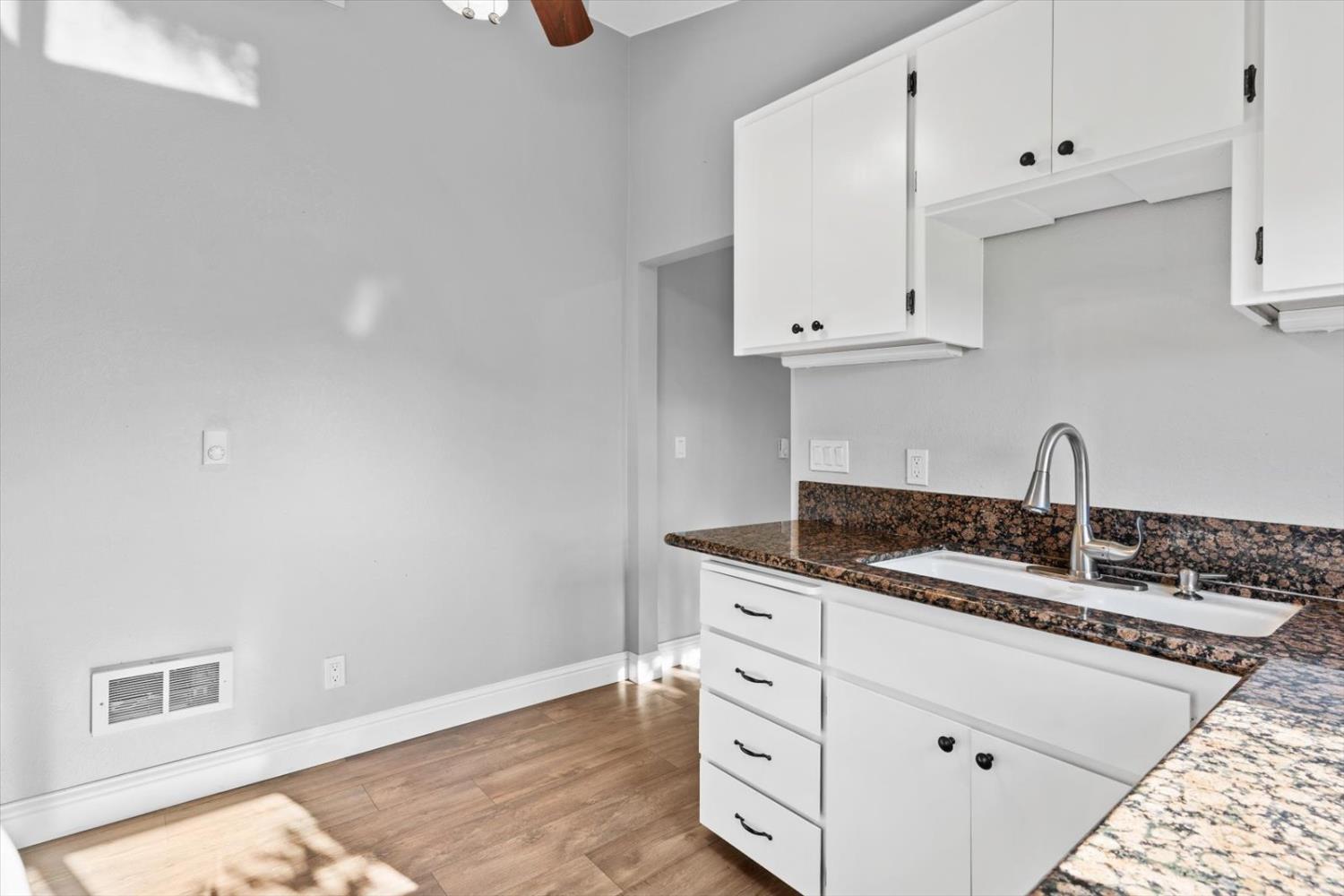 8335 Bailey Road Yuba City, CA 95993 - Photo 14 of 56 a kitchen with granite countertop white cabinets and sink