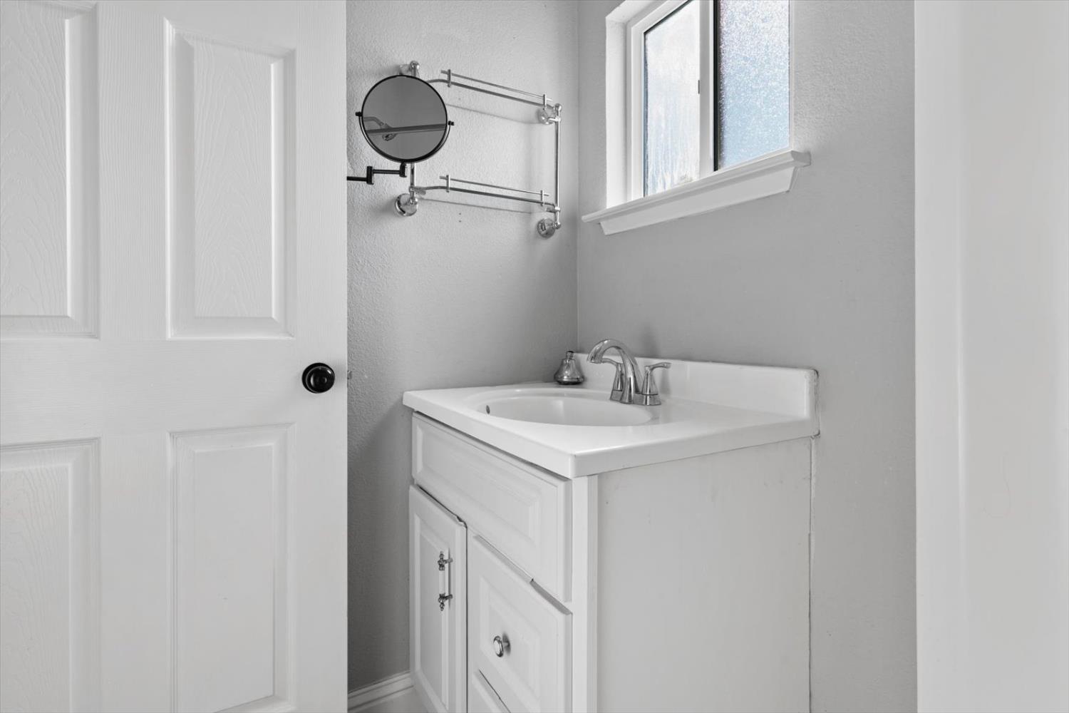 8335 Bailey Road Yuba City, CA 95993 - Photo 17 of 56 a bathroom with a sink a vanity and a mirror