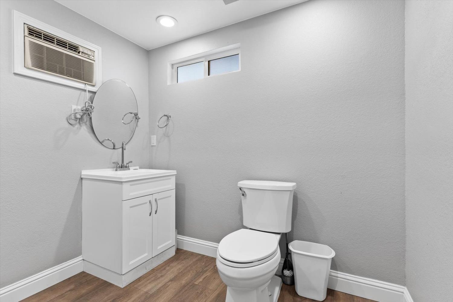 8335 Bailey Road Yuba City, CA 95993 - Photo 20 of 56 a bathroom with a toilet a sink and mirror