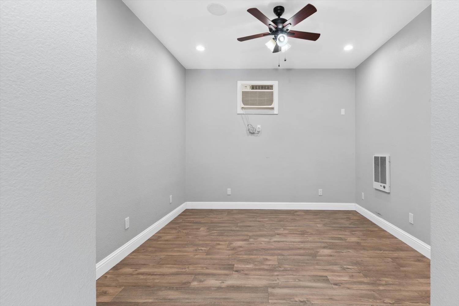 8335 Bailey Road Yuba City, CA 95993 - Photo 36 of 56 a view of a big room with wooden floor and a ceiling fan