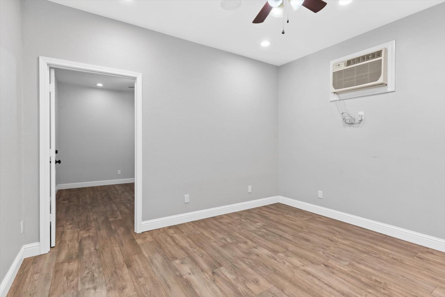8335 Bailey Road Yuba City, CA 95993 - Photo 37 of 56 an empty room with wooden floor and windows