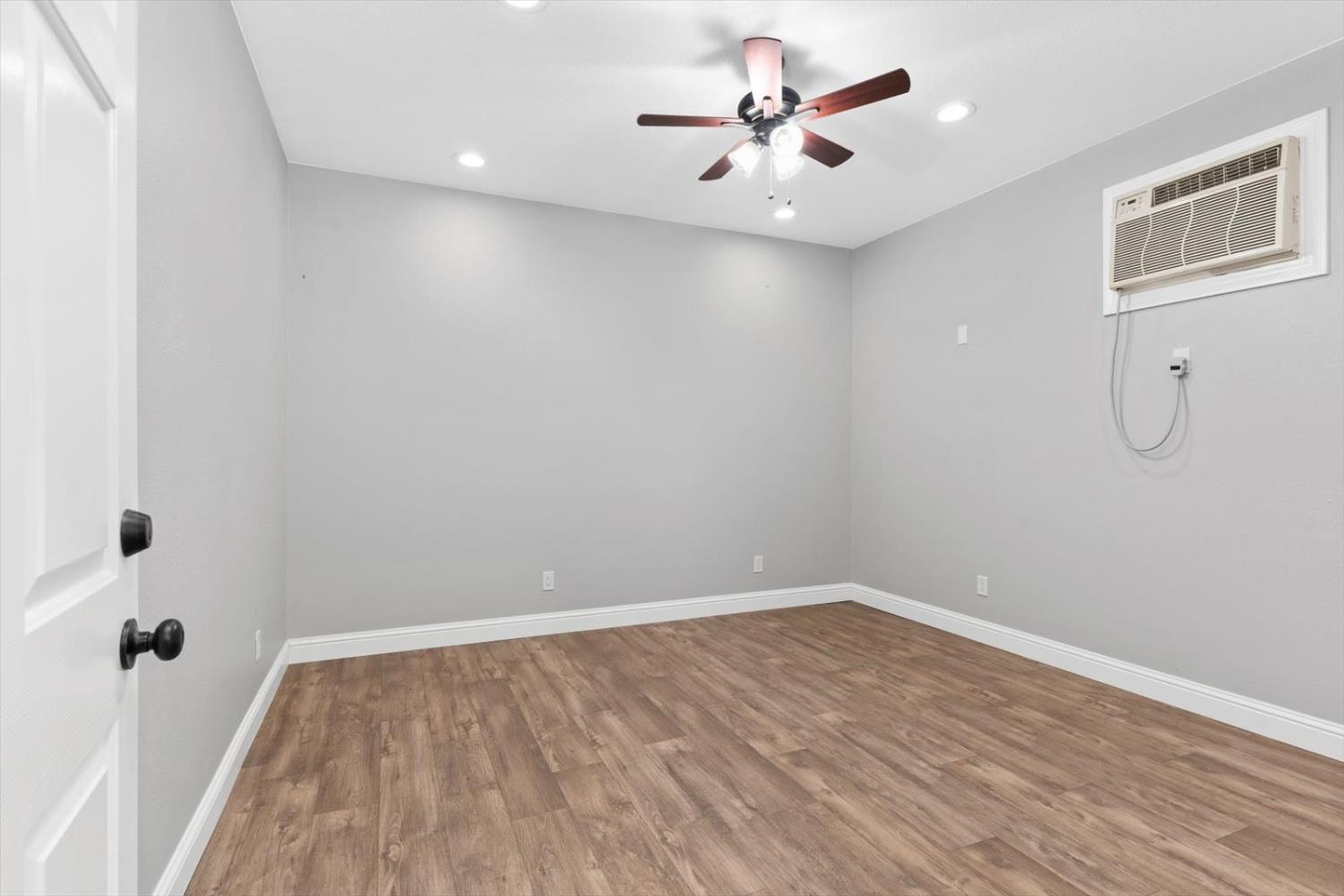 8335 Bailey Road Yuba City, CA 95993 - Photo 39 of 56 a view of a room with wooden floor and a ceiling fan