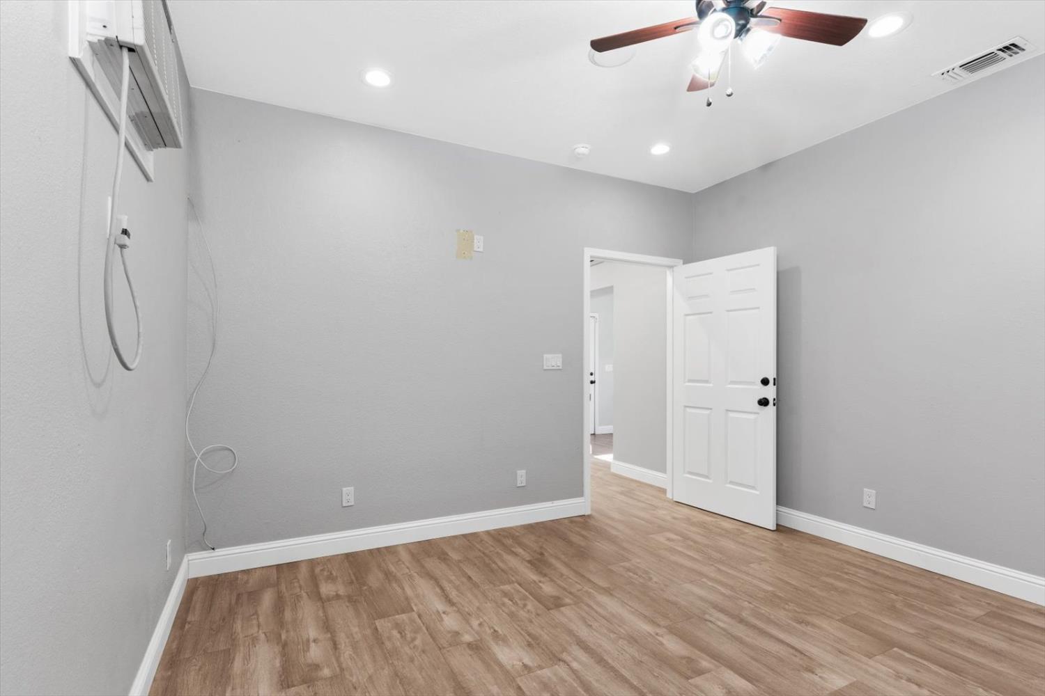 8335 Bailey Road Yuba City, CA 95993 - Photo 40 of 56 wooden floor in an empty room with a window