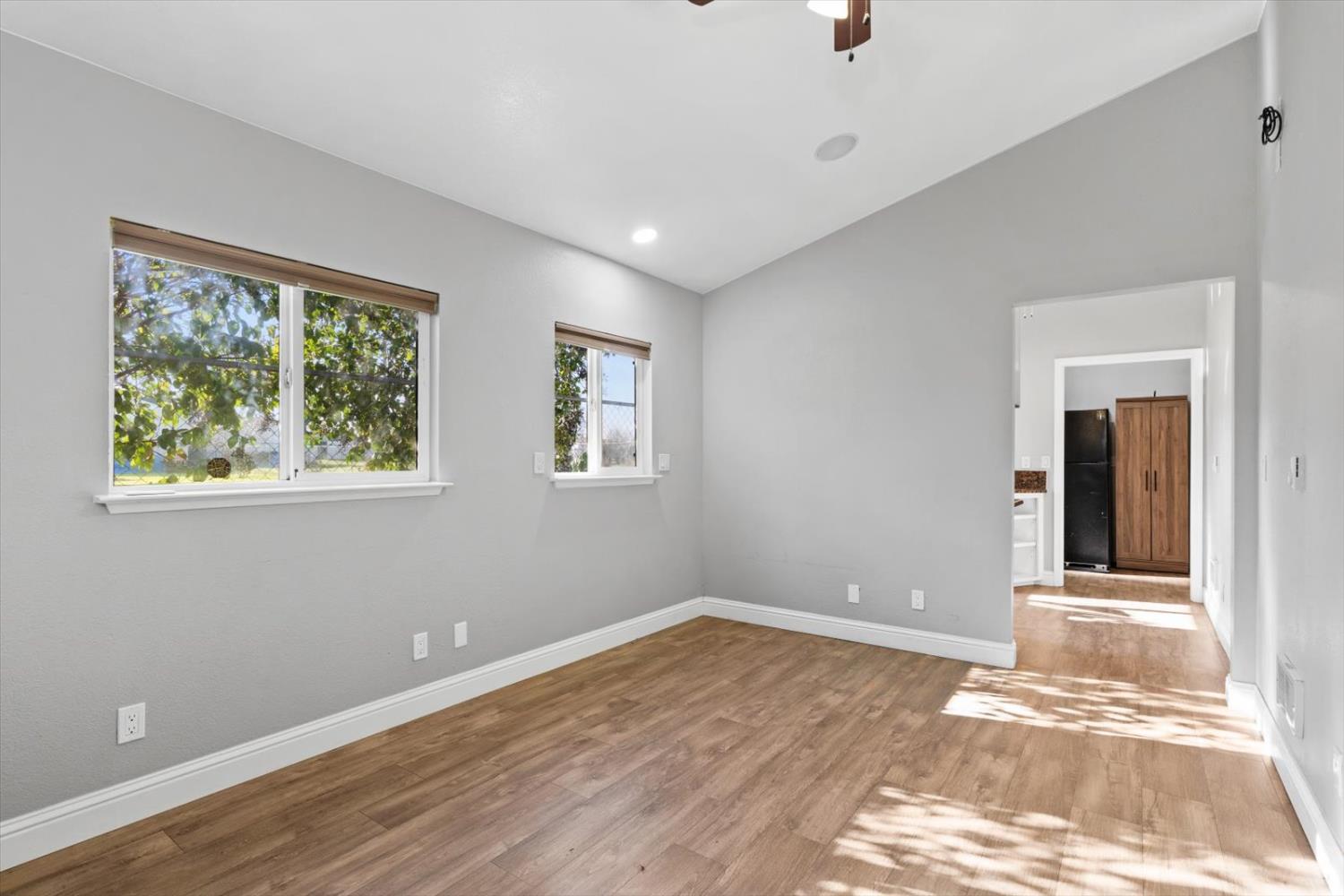 8335 Bailey Road Yuba City, CA 95993 - Photo 6 of 56 a view of an empty room with wooden floor and a window