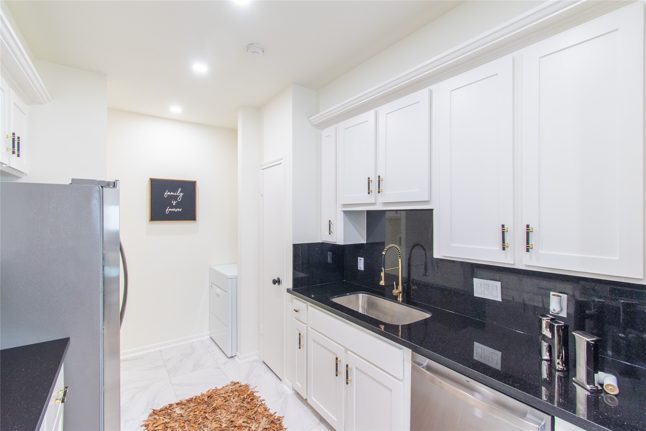 727 Bunker Hill Road, Unit 43 Houston, TX 77024 - Photo 17 of 36 a kitchen with stainless steel appliances granite countertop a refrigerator and sink