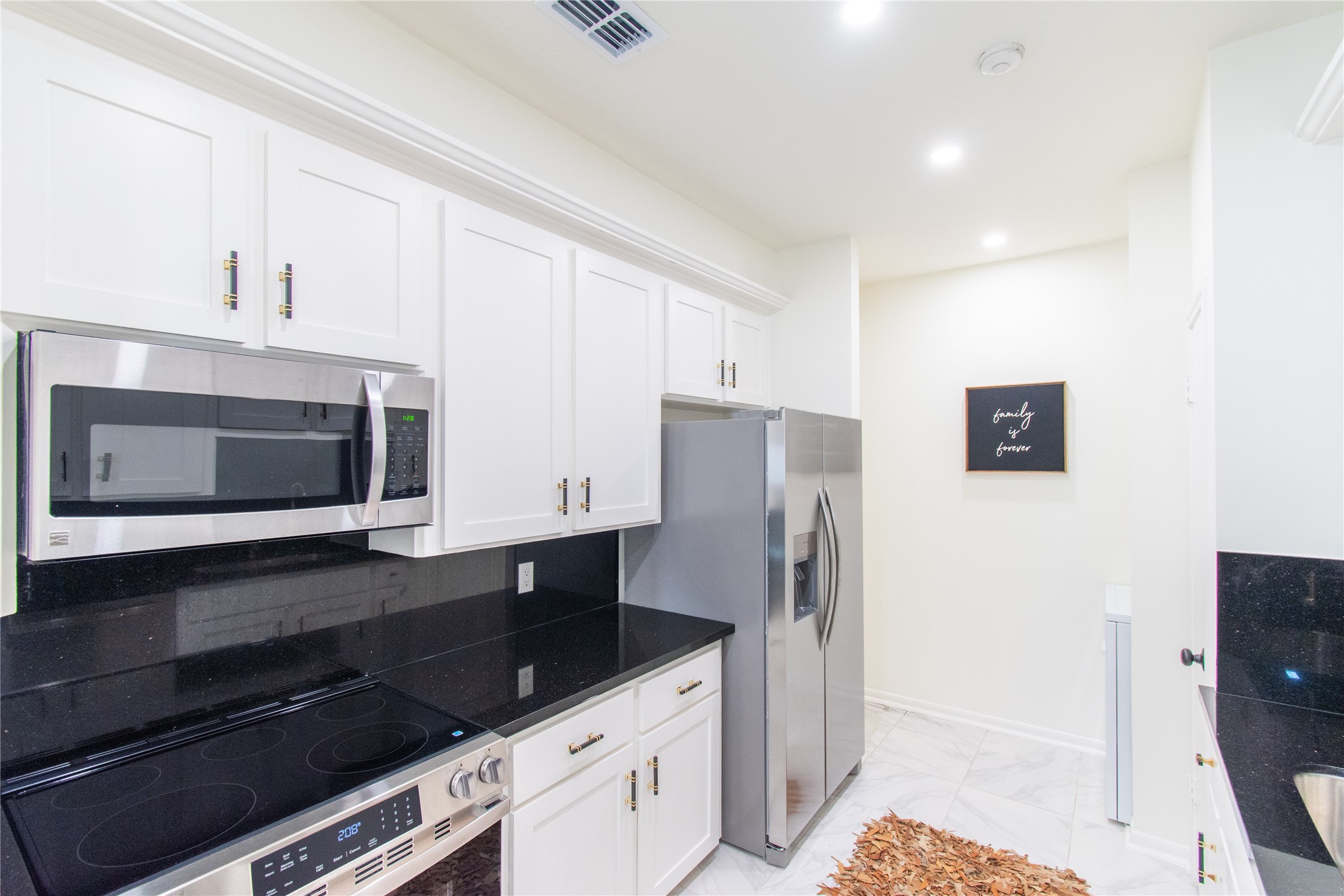 727 Bunker Hill Road, Unit 43 Houston, TX 77024 - Photo 18 of 36 a kitchen with stainless steel appliances a stove a microwave and a refrigerator