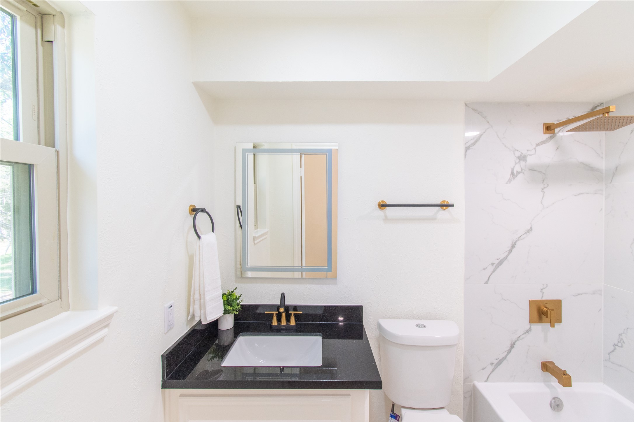 727 Bunker Hill Road, Unit 43 Houston, TX 77024 - Photo 26 of 36 a bathroom with a sink a toilet and a mirror