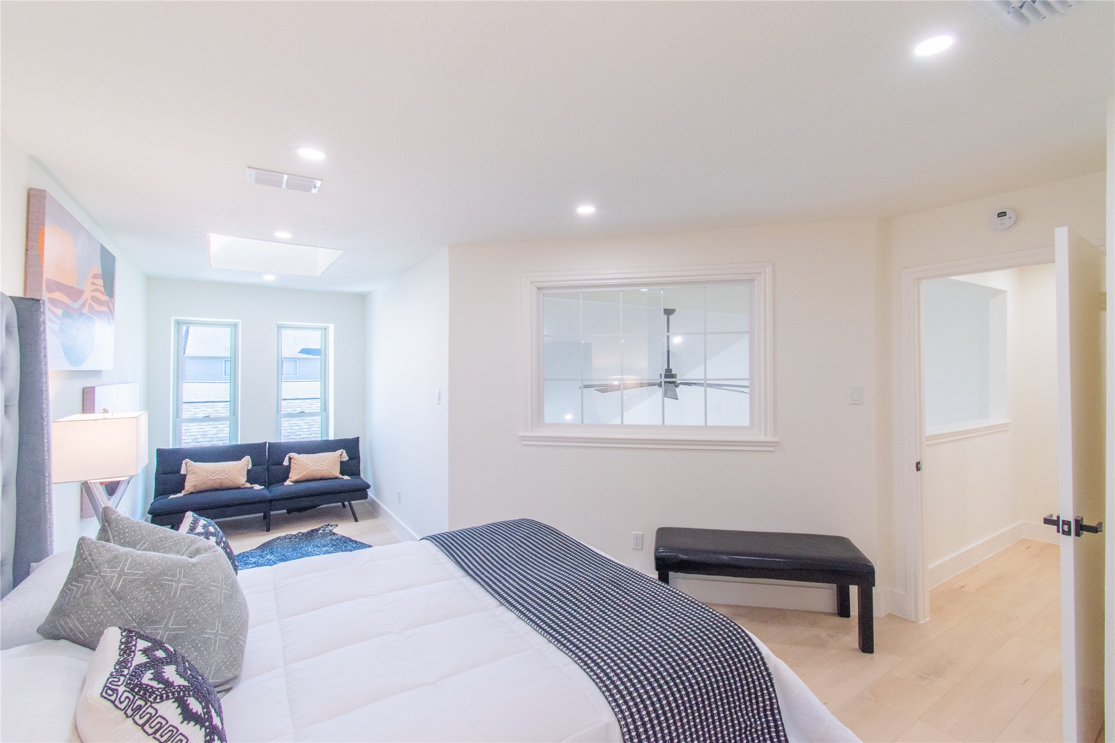 727 Bunker Hill Road, Unit 43 Houston, TX 77024 - Photo 29 of 36 a bedroom with a bed and wooden floor