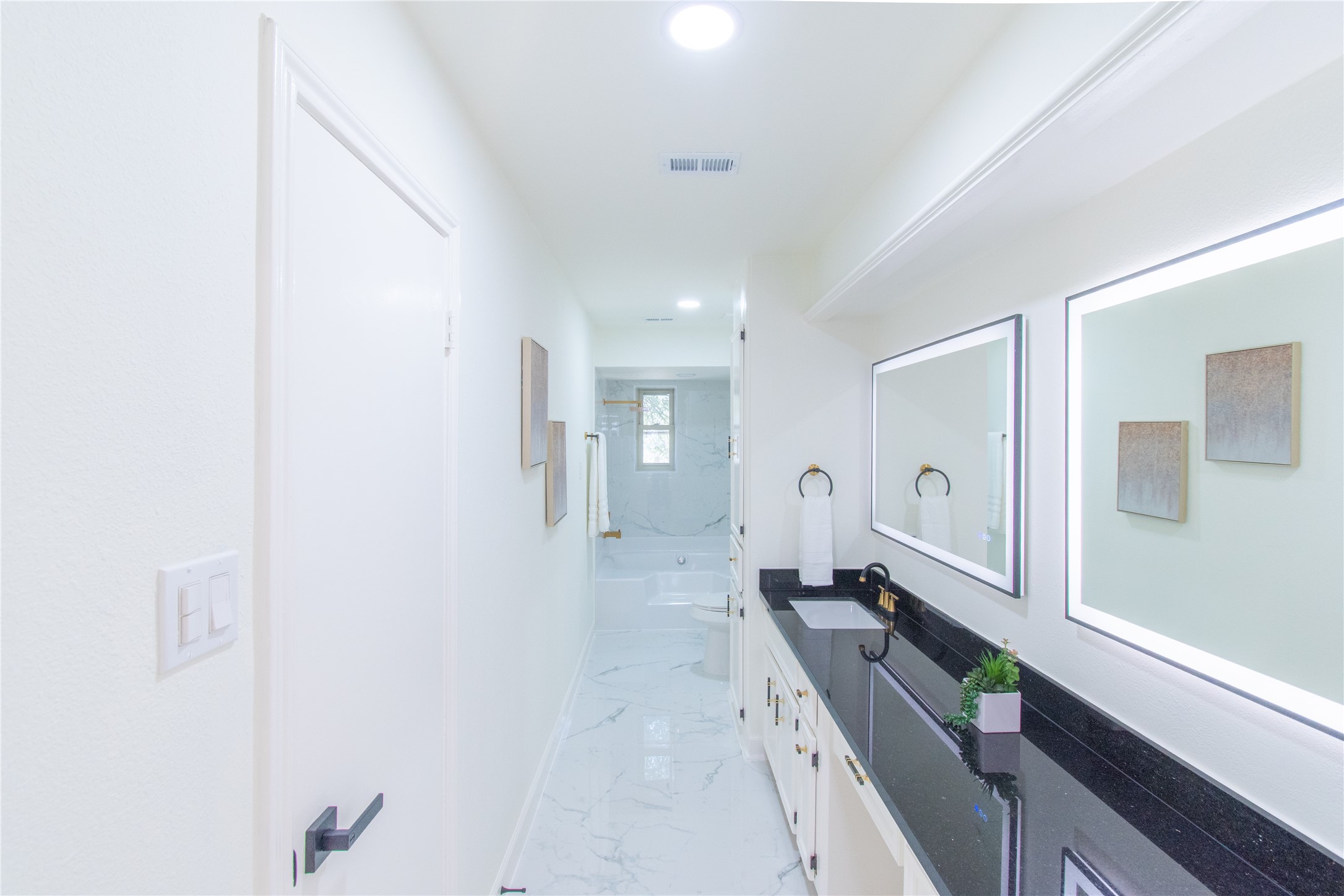 727 Bunker Hill Road, Unit 43 Houston, TX 77024 - Photo 31 of 36 a large bathroom with a double vanity sink and mirror