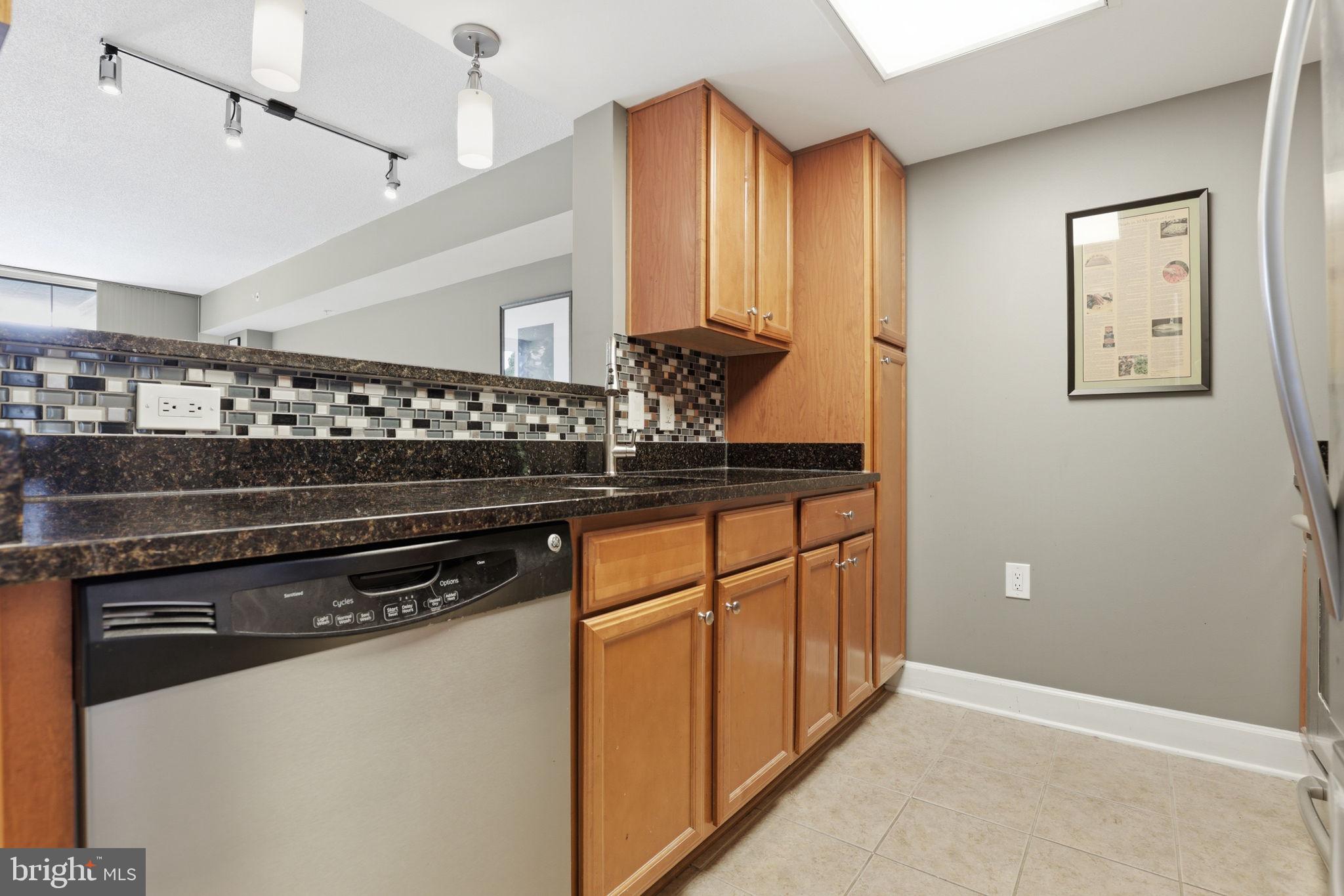 11800 Sunset Hills Road, Unit 218 Reston, VA 20190 - Photo 11 of 38 a kitchen with stainless steel appliances granite countertop a stove and a refrigerator