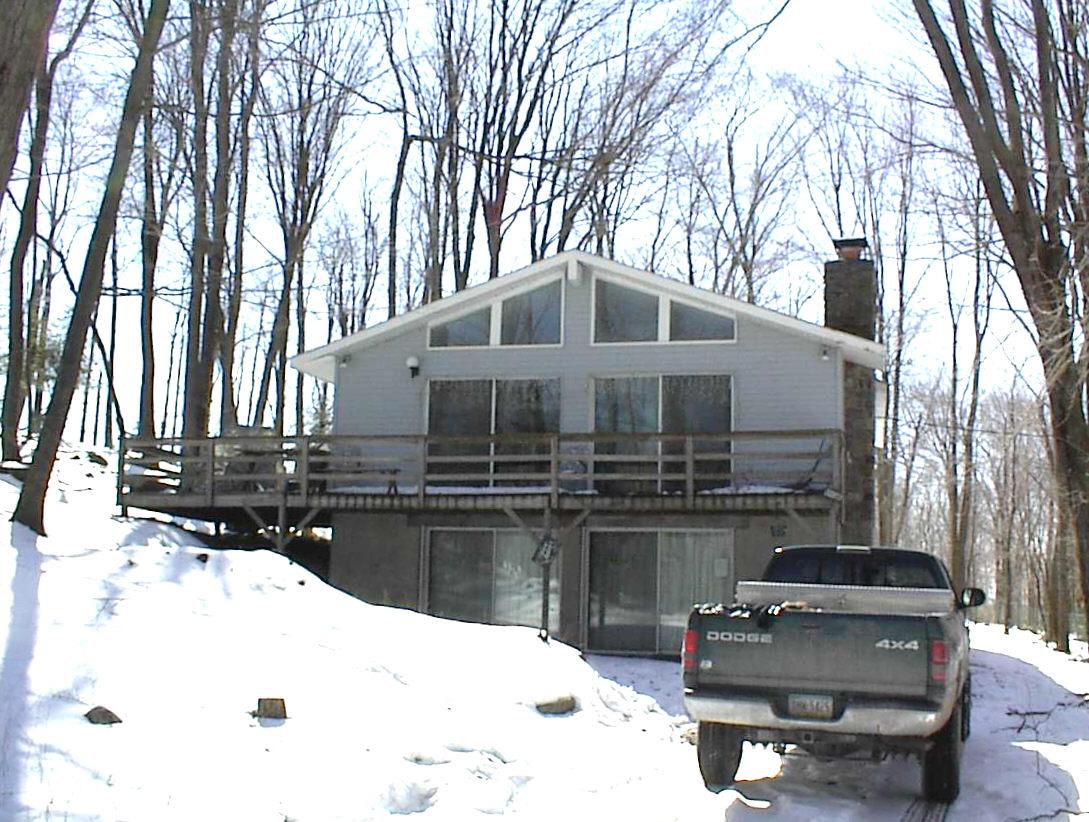 11 B Fawn Road Pocono Lake, PA 18347 - Photo 1 of 1 a large white building with a large trees covered with snow in front of it