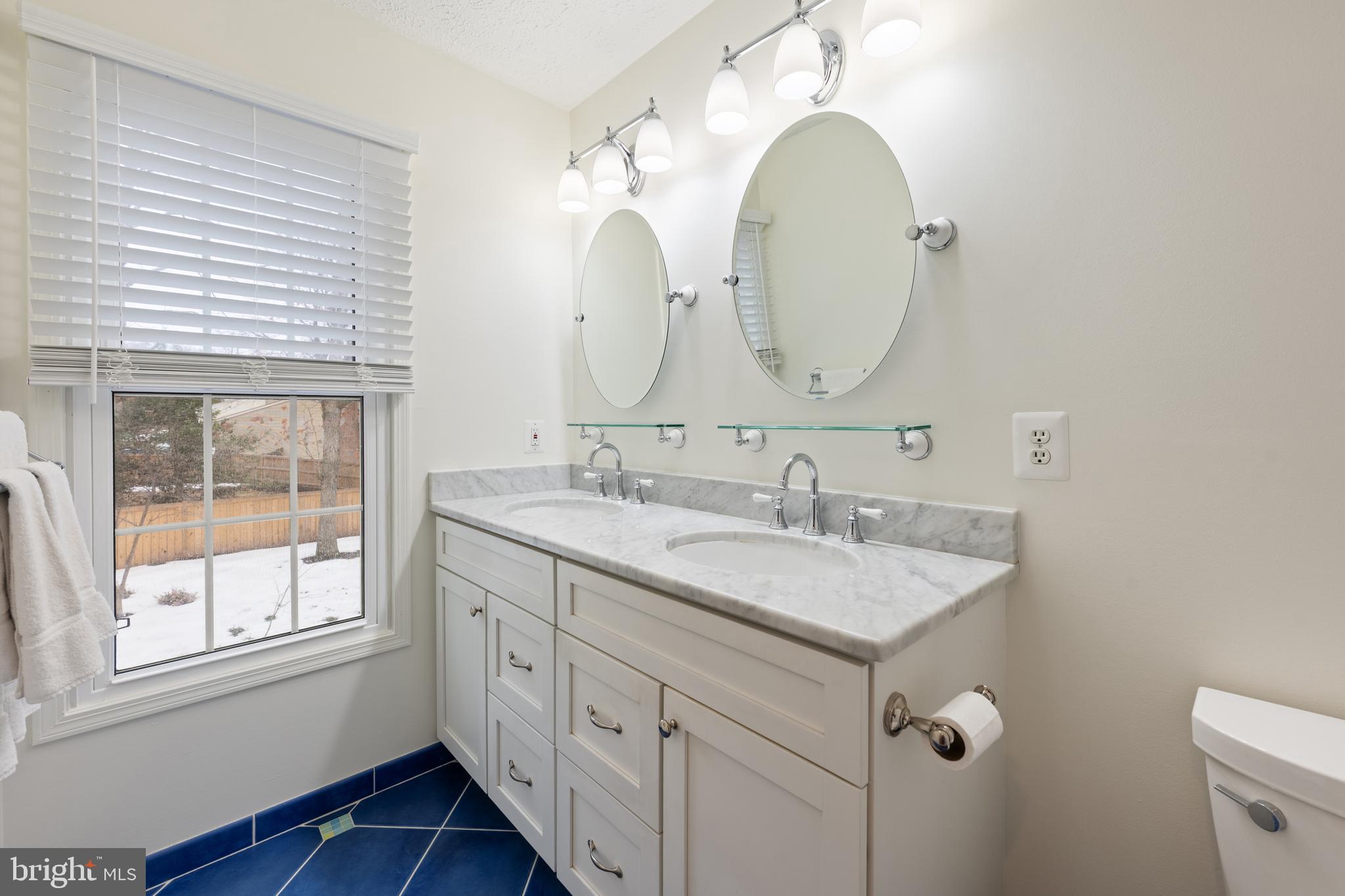 1374 Rock Chapel Road Herndon, VA 20170 - Photo 18 of 38 a bathroom with a double vanity sink and a mirror