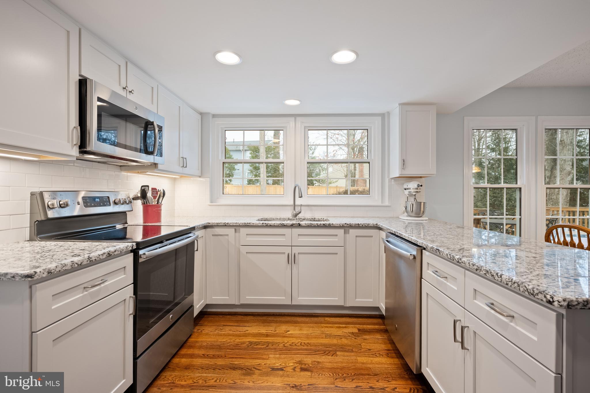 1374 Rock Chapel Road Herndon, VA 20170 - Photo 2 of 38 a kitchen with stainless steel appliances granite countertop a sink and dishwasher a stove top oven with wooden floor
