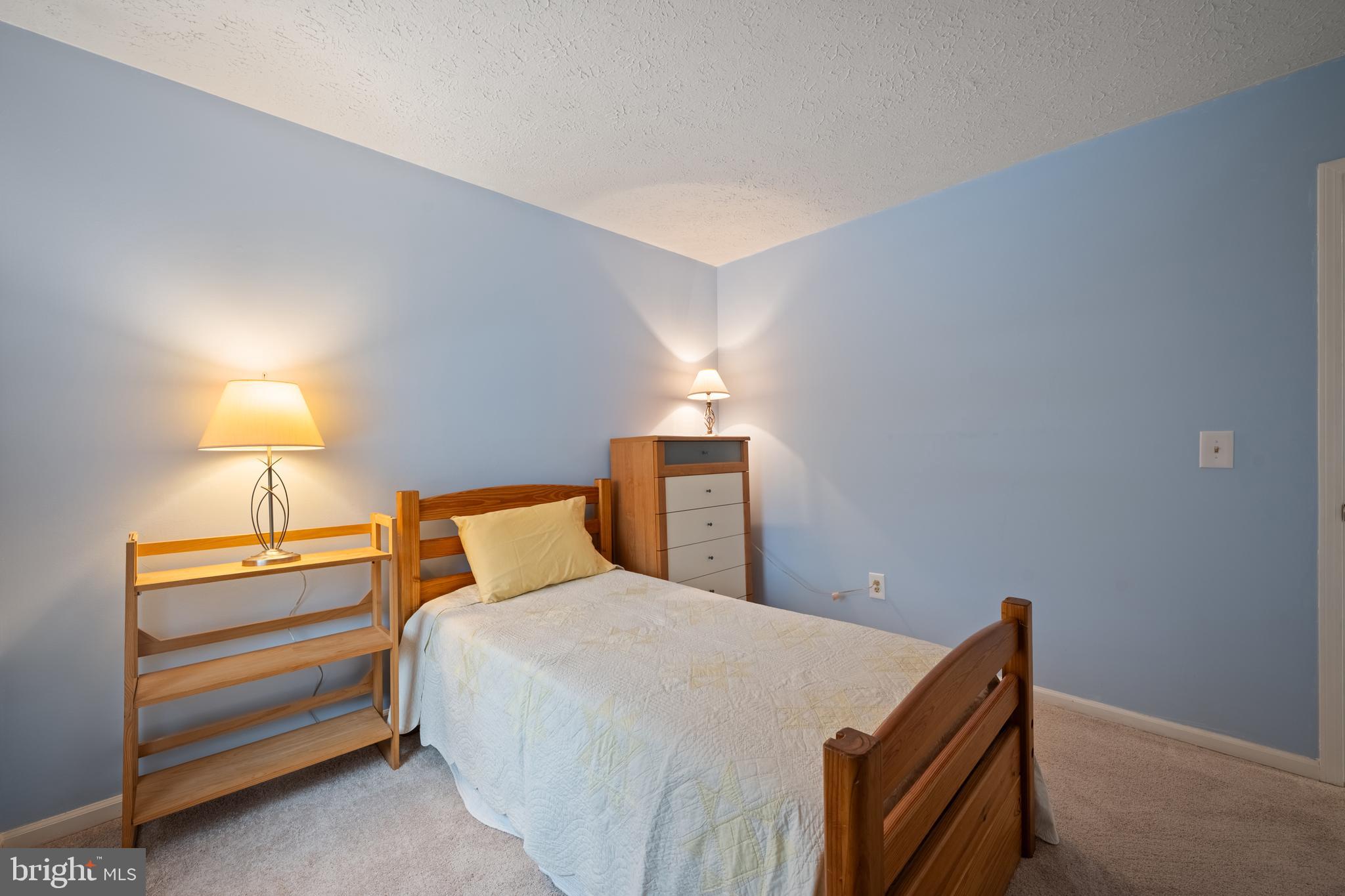 1374 Rock Chapel Road Herndon, VA 20170 - Photo 24 of 38 a bedroom with a bed and a lamp